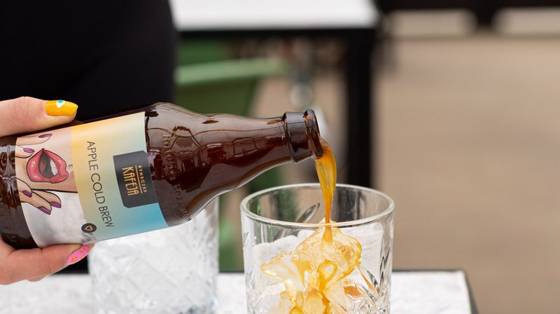 Cold brew being poured over ice, styled for a web and branding project